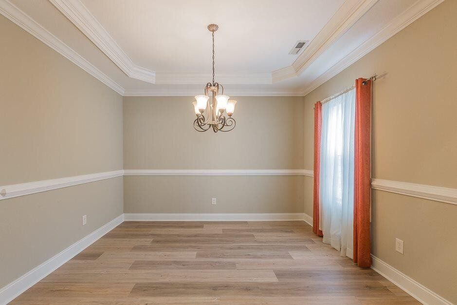 The separate dining room, with the trey ceiling and crown molding the builder advertised