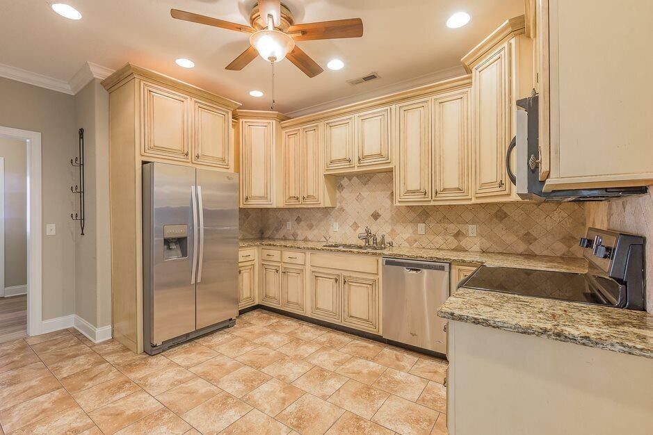 The kitchen: glazed cream cabinets, granite counters and stainless appliances, original to the 2008-09 build